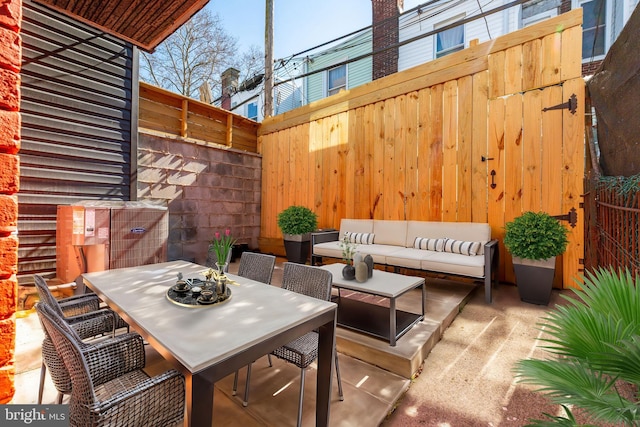 view of patio with outdoor lounge area, outdoor dining area, and fence