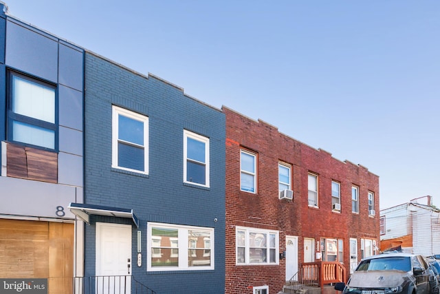 view of front of house featuring brick siding and cooling unit