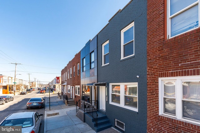 exterior space featuring a residential view and brick siding