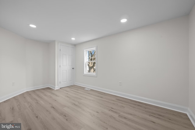 empty room with recessed lighting, baseboards, and wood finished floors