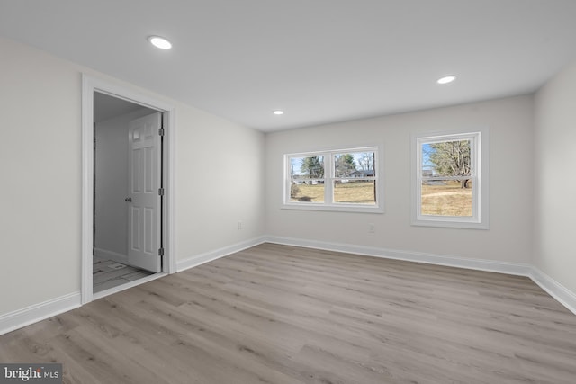 unfurnished room featuring recessed lighting, baseboards, and wood finished floors