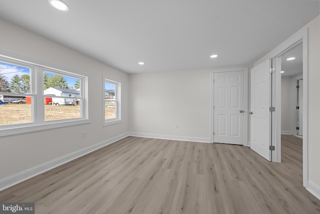 interior space featuring recessed lighting, light wood-style floors, and baseboards