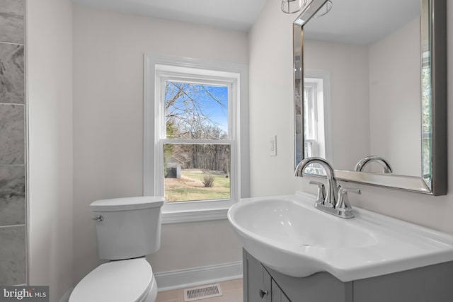 bathroom with visible vents, baseboards, toilet, tile patterned floors, and vanity