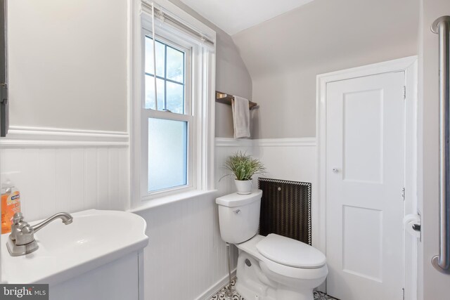 1175 Letort Rd, Conestoga, PA 17516 - half bath featuring wainscoting, toilet, vaulted ceiling, a decorative wall, and vanity