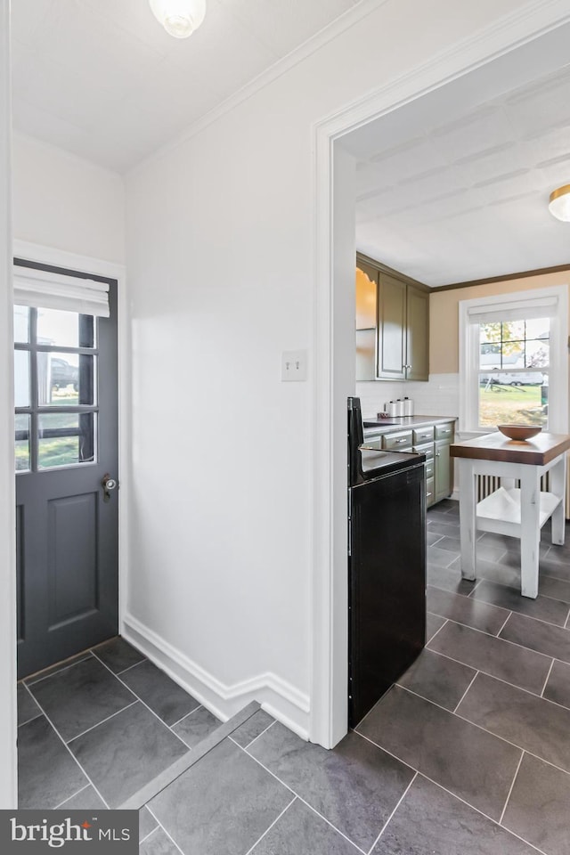 1175 Letort Rd, Conestoga, PA 17516 - kitchen featuring dark tile patterned floors, crown molding, and baseboards