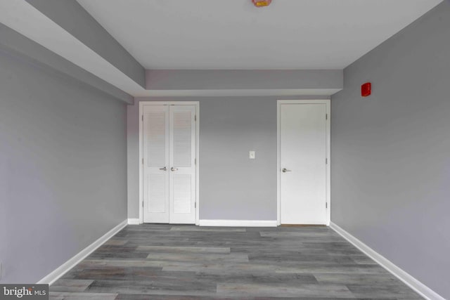 spare room featuring wood finished floors and baseboards