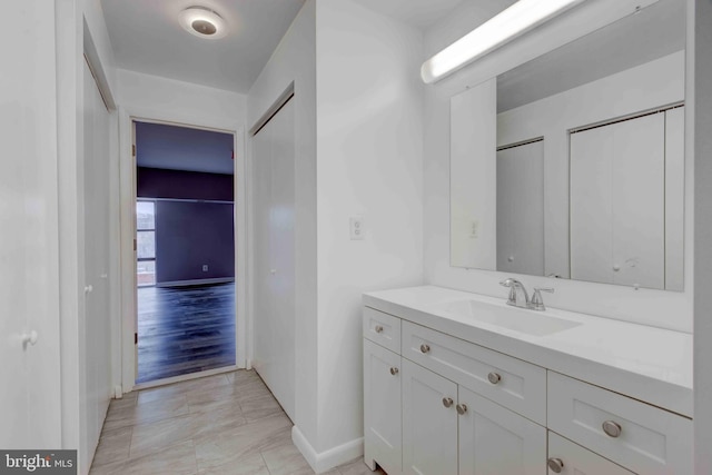 bathroom featuring baseboards and vanity