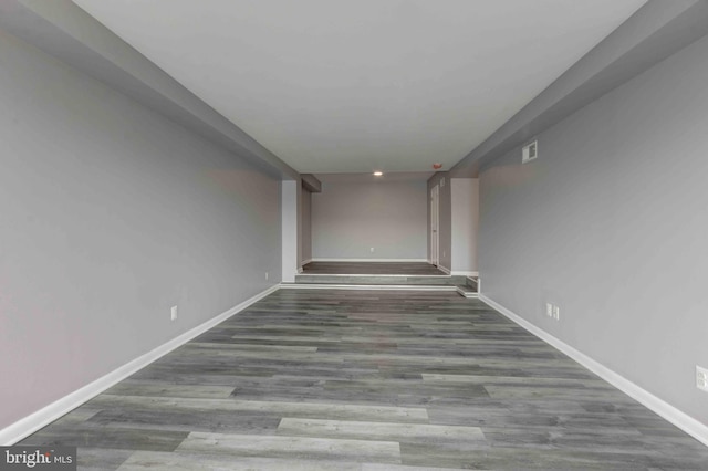 interior space featuring visible vents, baseboards, and wood finished floors