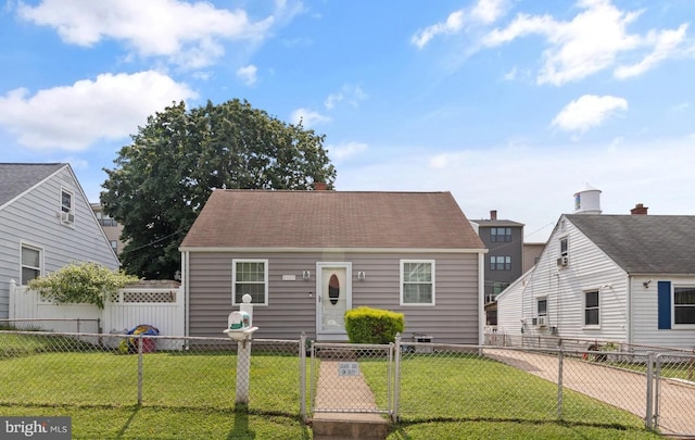 view of front of house with a fenced front yard, a front yard, and a gate