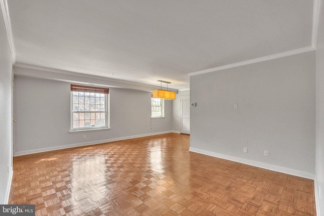 empty room with crown molding and baseboards