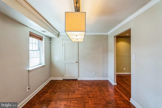 empty room featuring visible vents, baseboards, and ornamental molding