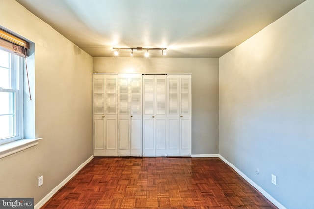 unfurnished bedroom featuring a closet and baseboards