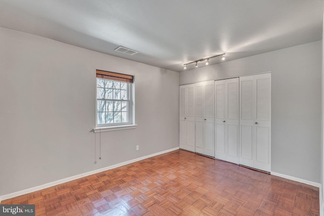 unfurnished bedroom featuring visible vents, baseboards, and a closet