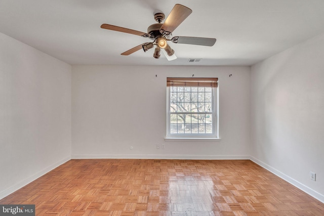 spare room with visible vents, baseboards, and a ceiling fan