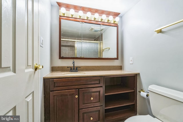 full bath featuring a shower stall, toilet, and vanity