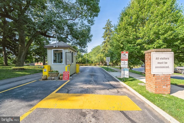 view of road with a gated entry and traffic signs