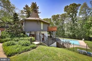 view of pool with a fenced in pool, a lawn, and fence