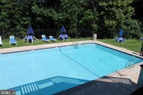 community pool featuring a yard