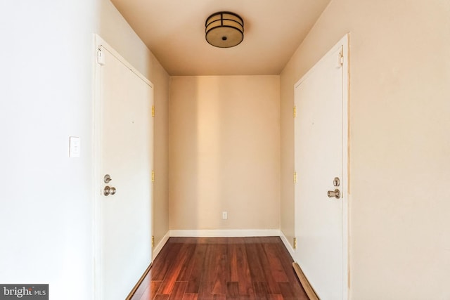 interior space with dark wood finished floors and baseboards