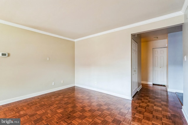 empty room with crown molding and baseboards