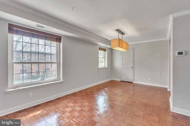 empty room featuring baseboards, visible vents, and ornamental molding