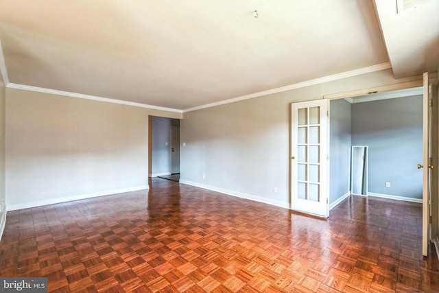 spare room featuring crown molding and baseboards