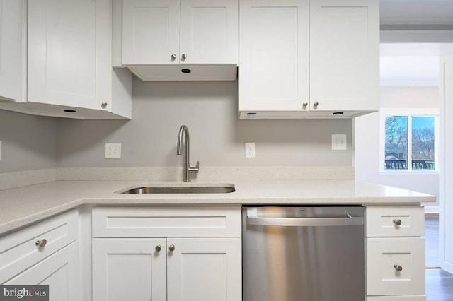 kitchen featuring a sink, light stone countertops, dishwasher, and white cabinets