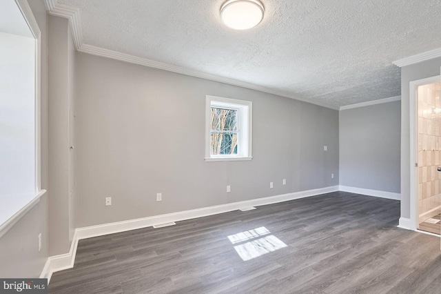 empty room featuring a textured ceiling, baseboards, dark wood-style flooring, and ornamental molding