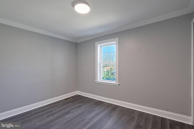 unfurnished room featuring crown molding, visible vents, baseboards, and dark wood-style flooring