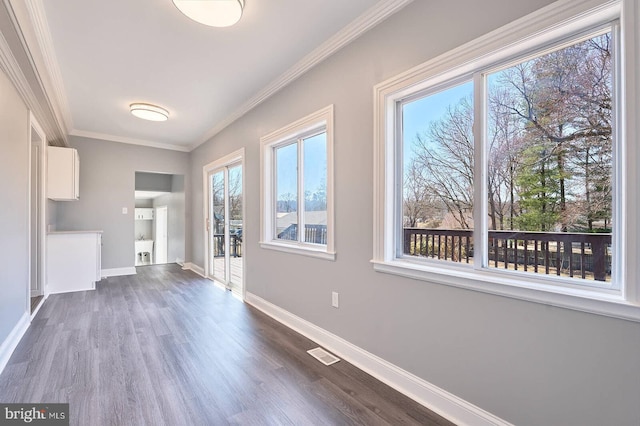 interior space with visible vents, baseboards, dark wood-style floors, and crown molding