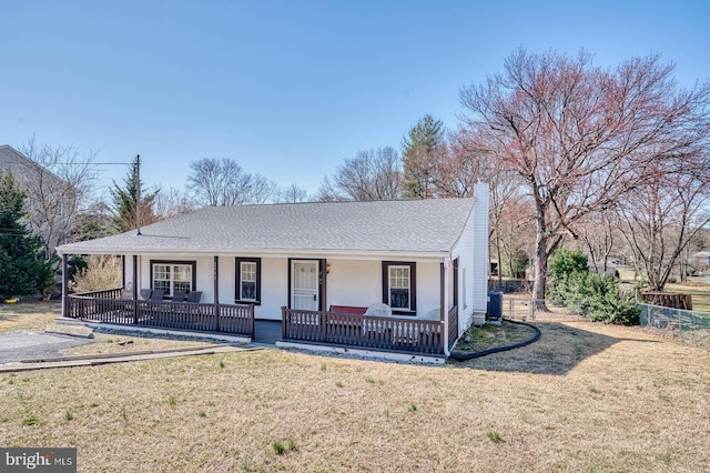 ranch-style house with a front lawn, a porch, central AC, stucco siding, and a chimney