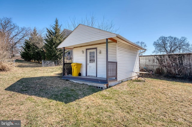 view of outdoor structure with an outbuilding and fence