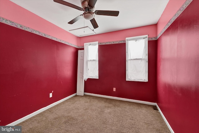 unfurnished room with a ceiling fan, carpet, and baseboards