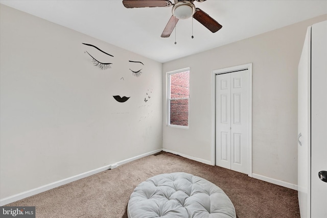 bedroom featuring a closet, ceiling fan, baseboards, and carpet