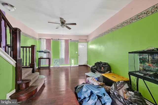 interior space with stairs, hardwood / wood-style flooring, a ceiling fan, and baseboards