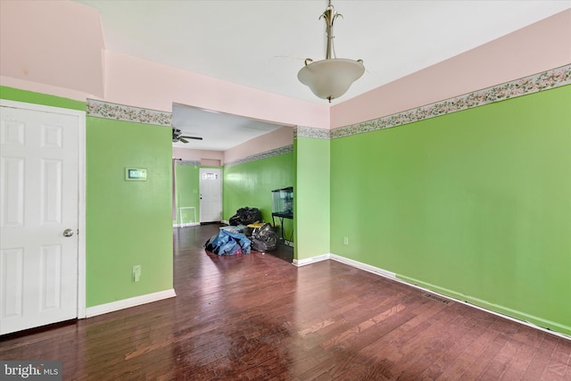 spare room with visible vents, baseboards, a ceiling fan, and hardwood / wood-style flooring