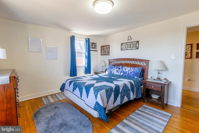 bedroom featuring baseboards and wood finished floors