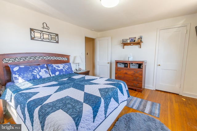 bedroom featuring baseboards and wood finished floors