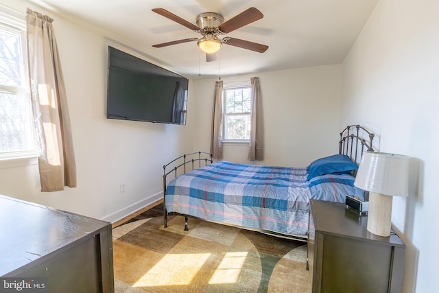 bedroom with baseboards and ceiling fan