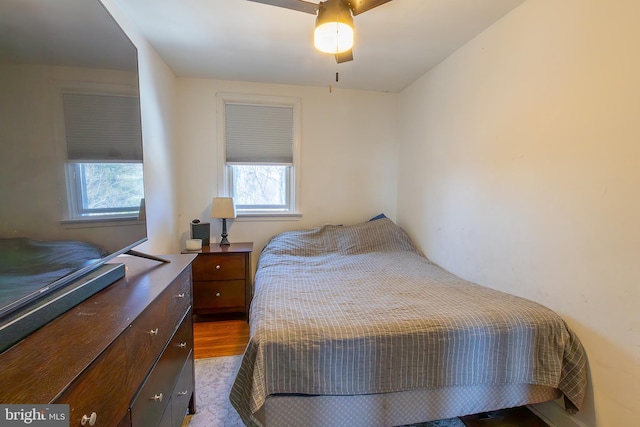 bedroom with dark wood-type flooring and ceiling fan