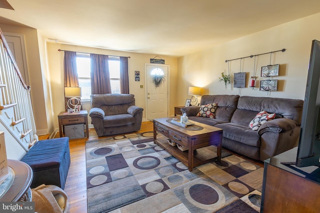 living room featuring stairway and wood finished floors