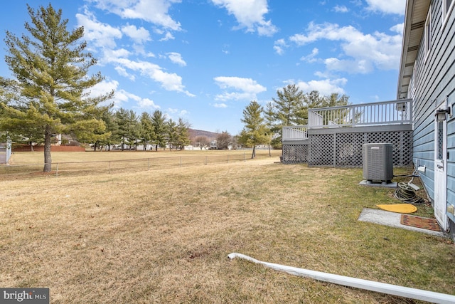 view of yard featuring central AC unit and a deck