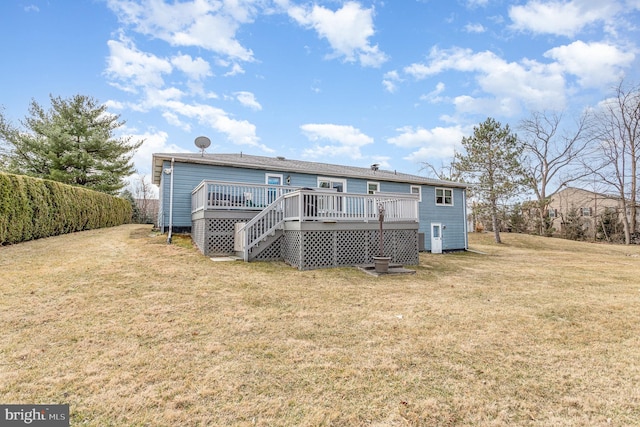 rear view of property featuring a lawn and a wooden deck