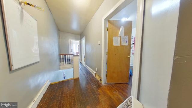 hallway with an upstairs landing and hardwood / wood-style flooring