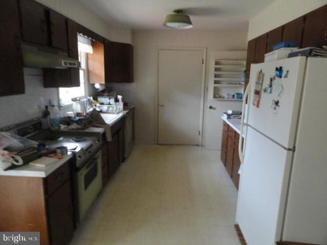 kitchen featuring under cabinet range hood, light floors, white appliances, and light countertops