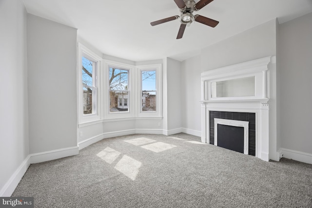 unfurnished living room featuring carpet flooring, a fireplace, and baseboards