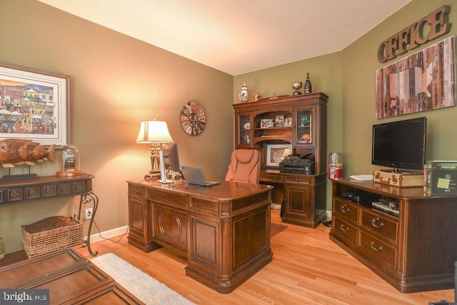 office space featuring baseboards and light wood-style floors