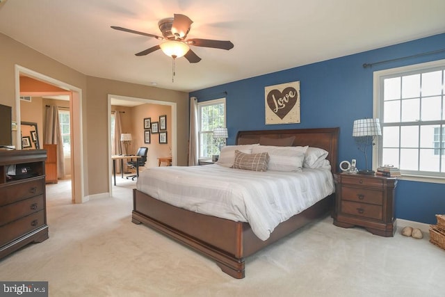 bedroom with light colored carpet, baseboards, and ceiling fan