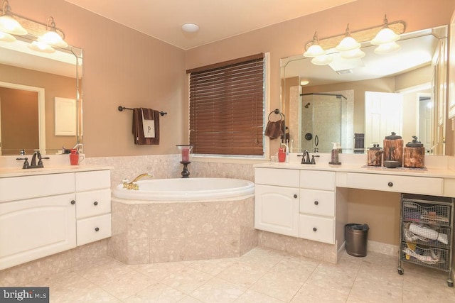 bathroom featuring a sink, a bath, a shower stall, and tile patterned flooring