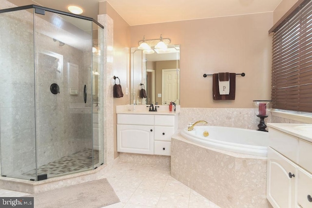 full bathroom featuring vanity, a shower stall, a garden tub, and tile patterned floors